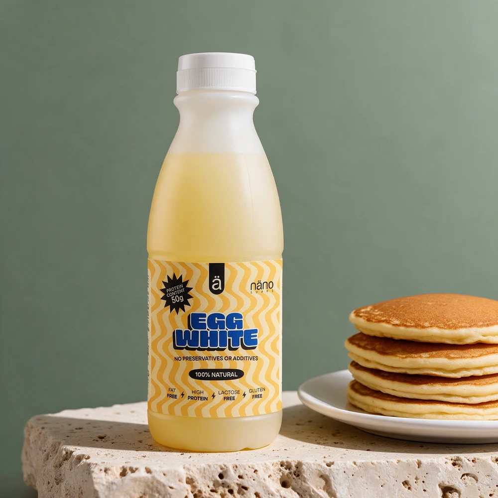 Nänosupps Egg White i halvliterflaske ved en stabel pannekaker