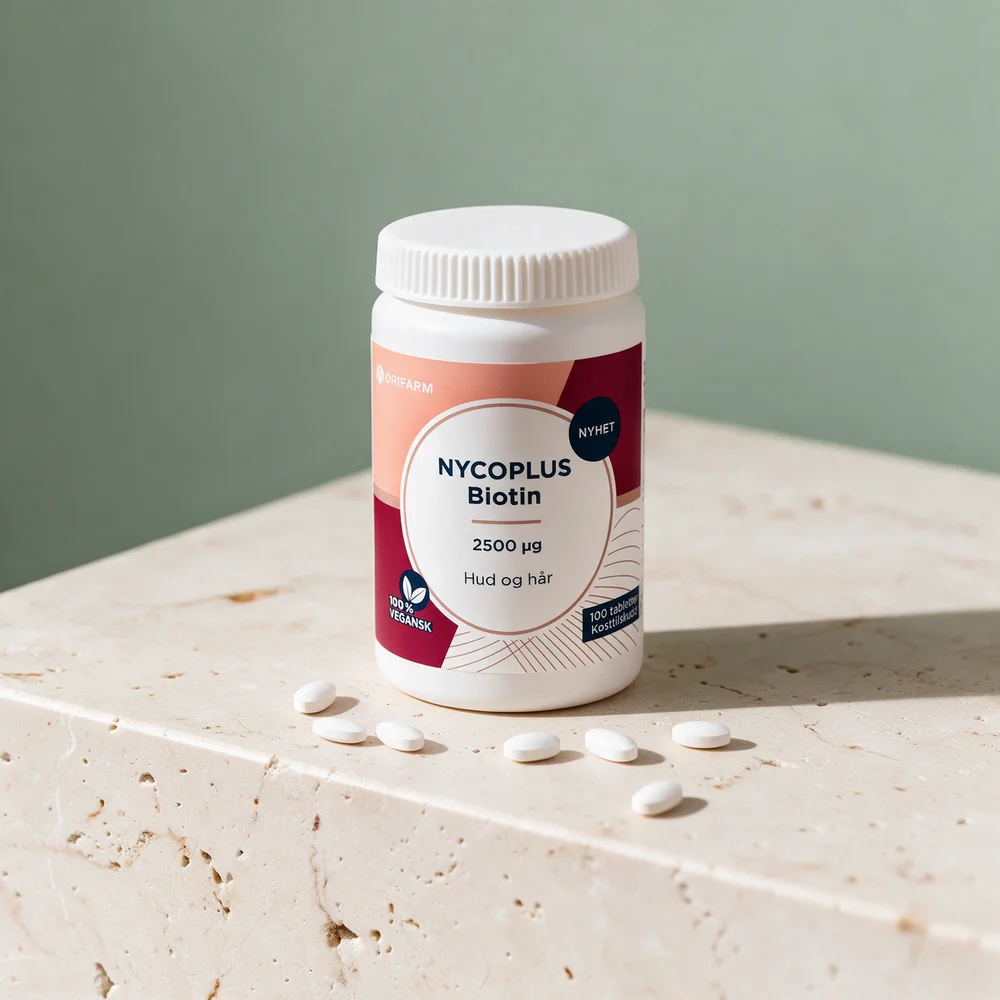 Nycoplus Biotin 2500 µg med små, ovale tabletter foran boksen