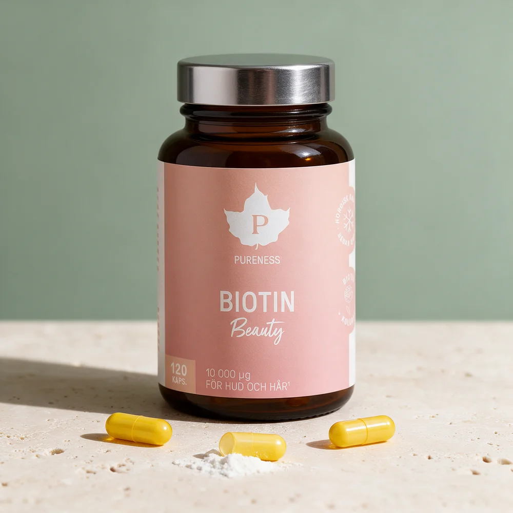 Pureness Biotin Beauty med kapsler og litt hvitt pulver foran glasset