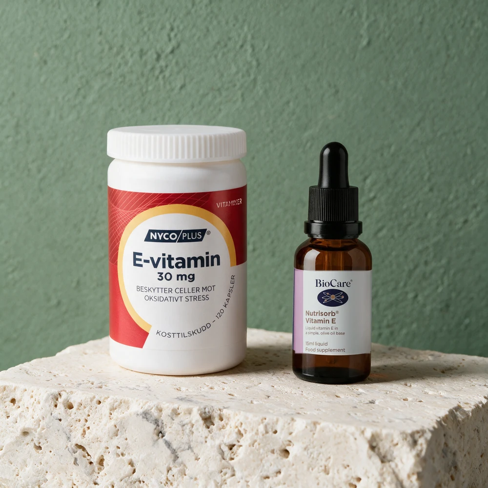 Nycoplus E-vitamin 30 mg, hvit boks med kapsler, og BioCare Nutrisorb, brun pipetteflaske med dråper