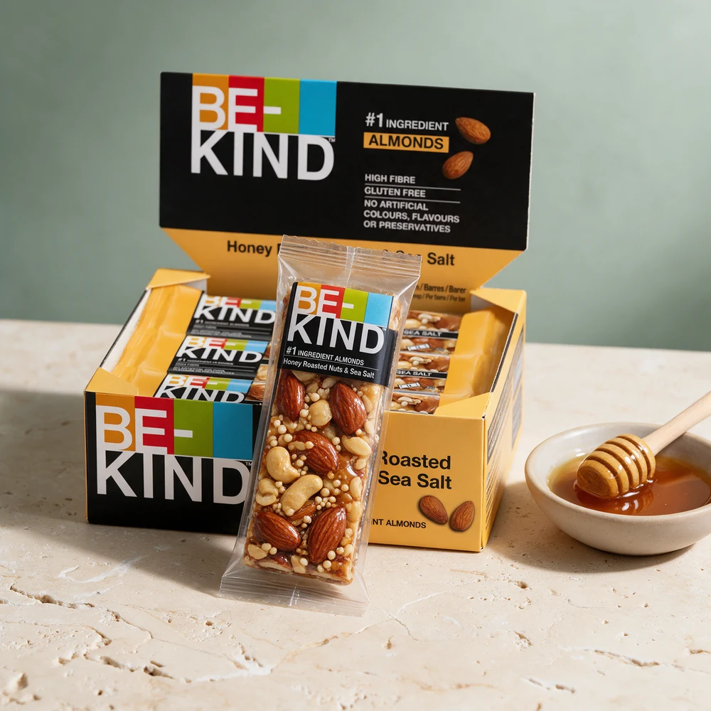 BE-KIND Core Honey Roasted Nuts & Sea Salt i klart omslag med hele mandler, peanøtter og cashew synlige, og honning