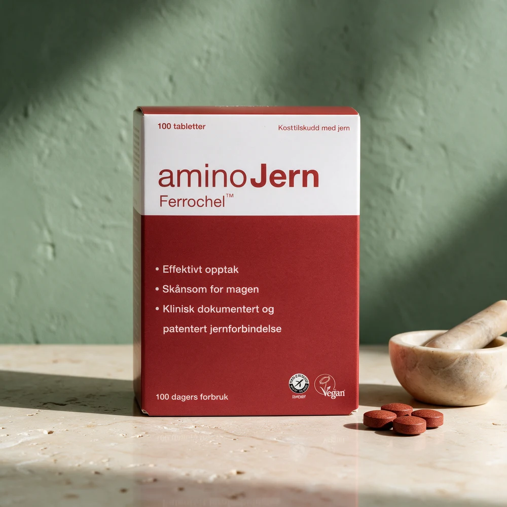 aminoJern Ferrochel, eske med 100 tabletter, og en morter med noen tabletter foran