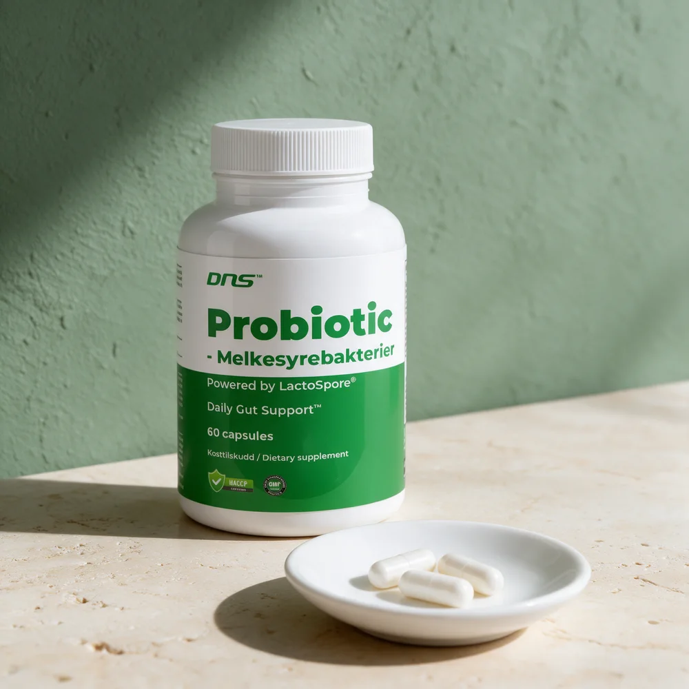 DNS Probiotic Lactospore, boks med 60 kapsler, med tre kapsler på et fat