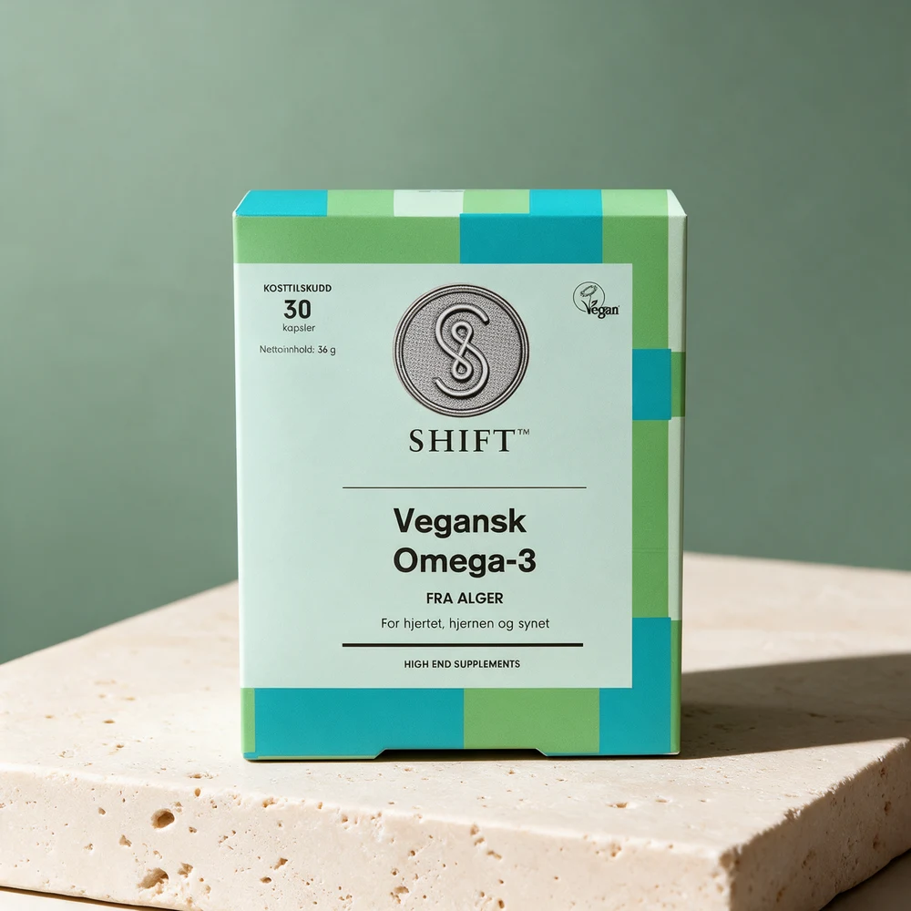 Shift Vegansk Omega-3 i eske med grønne og turkise felt på et travertinbord