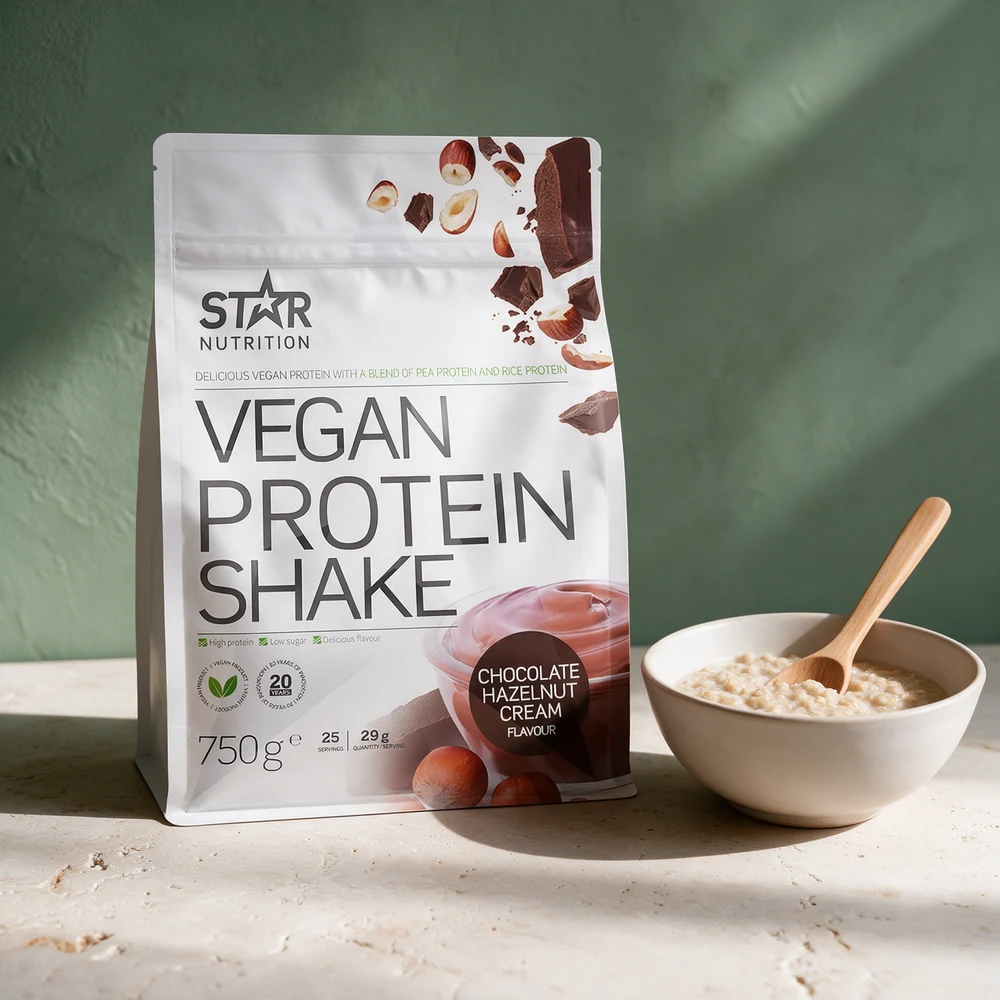Star Nutrition Vegan Protein Shake i pose ved en skål havregrøt på et travertinbord