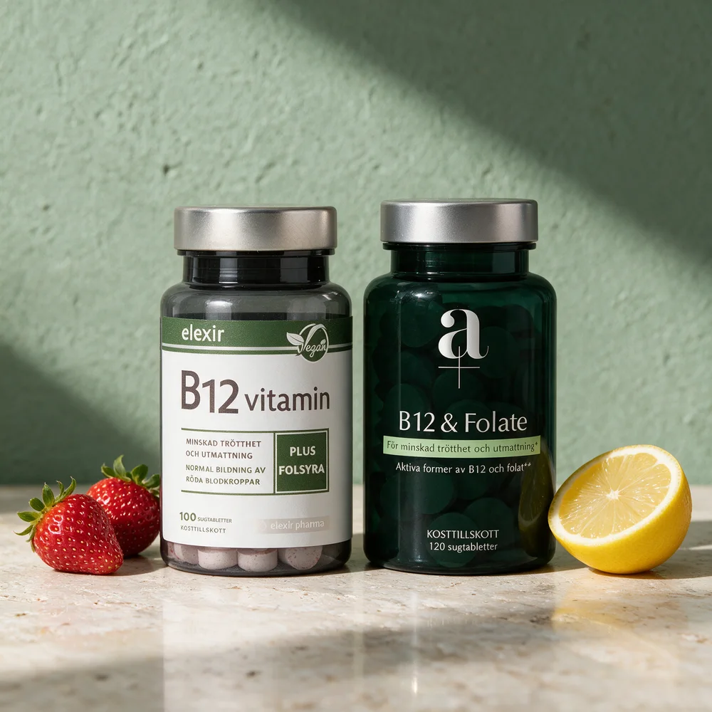 Elexir Pharma B-12 Vegan og Alpha Plus Metyl B12 & Folat mellom jordbær og en halv sitron på et travertinbord