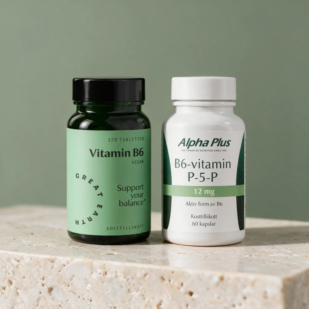 Great Earth Vitamin B6 i mørkegrønn boks og Alpha Plus B6-vitamin P-5-P i hvit boks side om side på et travertinbord